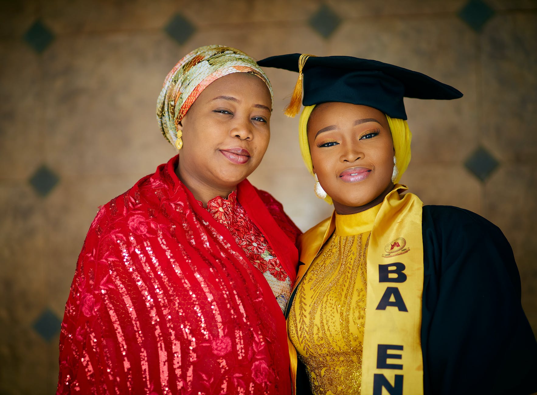 woman posing with student after graduation